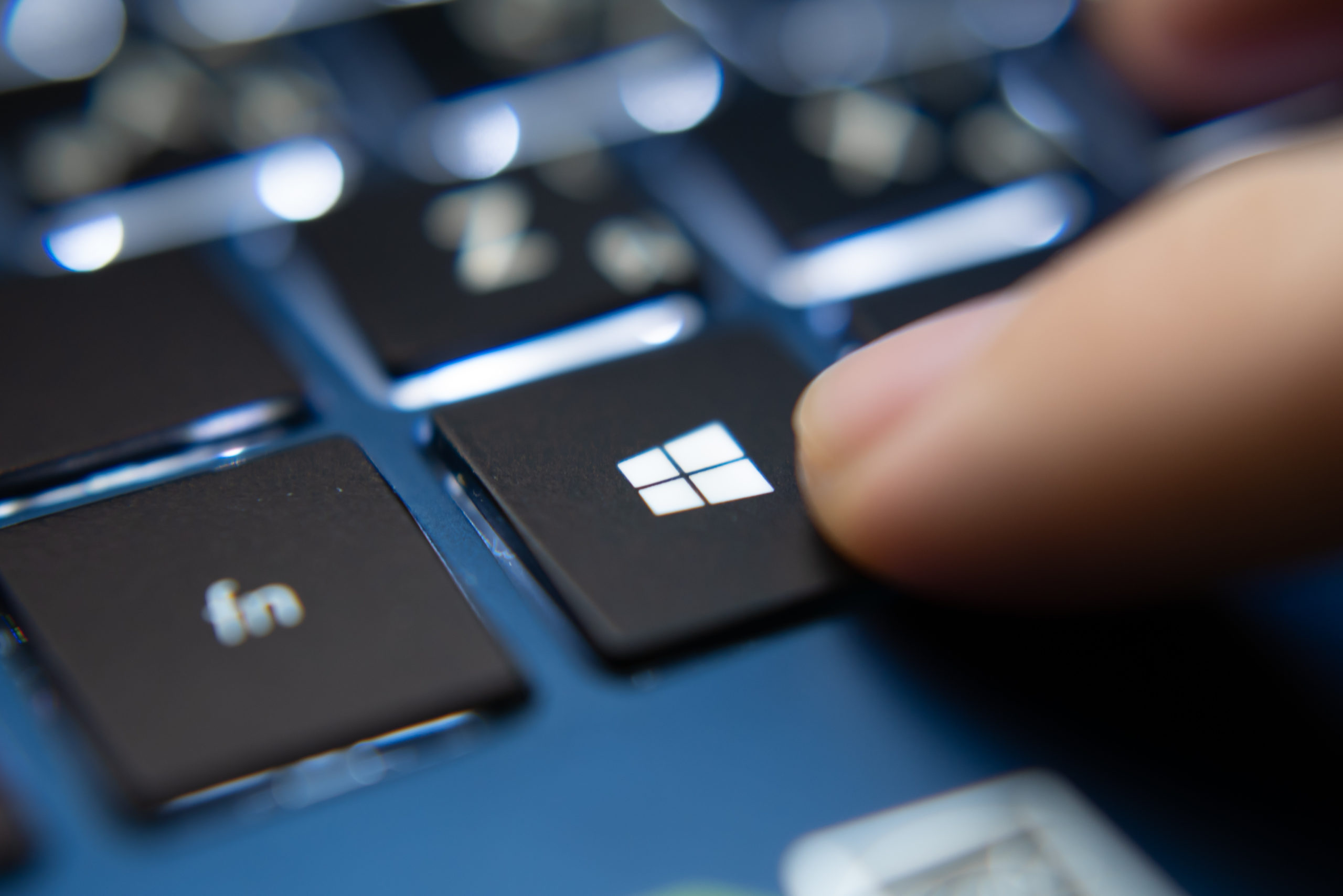 Laptop user pressing Windows Key on Microsoft Windows keyboard after learning how to get to Control Panel on Windows 10.